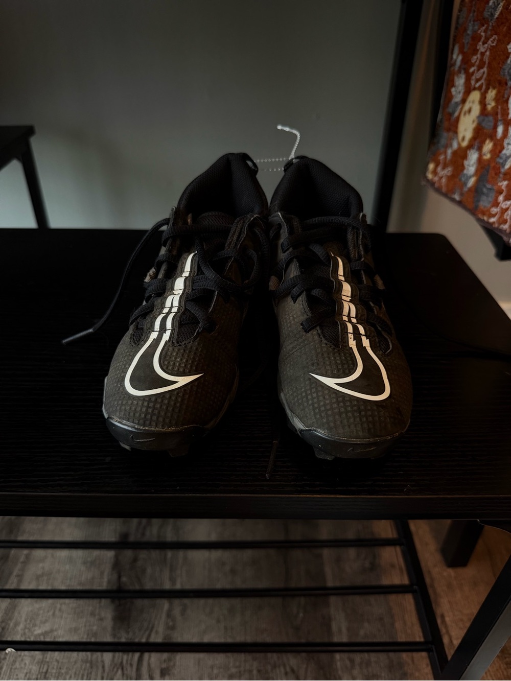 Nike Men’s Black Athletic Cleats with White Swoosh and Stripe Accents